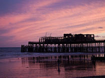 Sunset over Hastings Pier remains